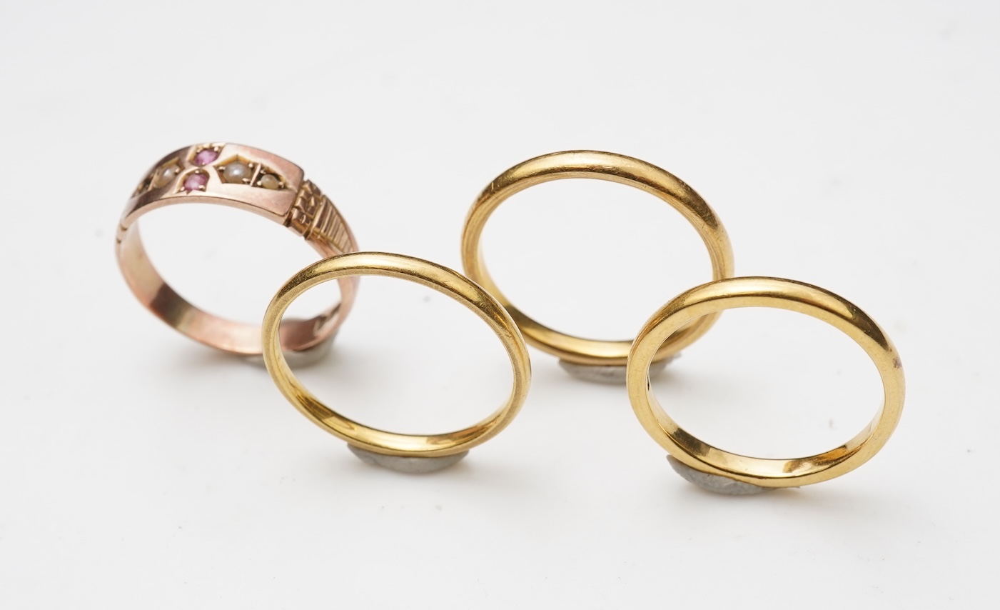 A collection of four gold rings